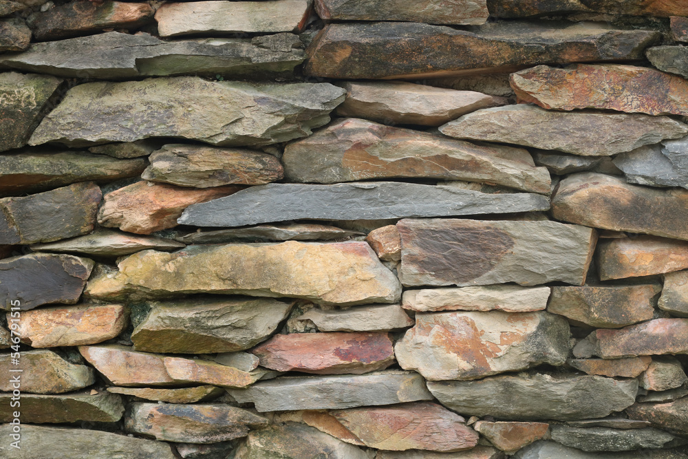 Fototapeta premium Old beautiful brick wall texture. Stacked Stone wall rock construction pattern. Marble wall texture background. Vintage brickwork backdrop