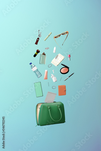 Feminine accessories coming out of a handbag. Purse contents