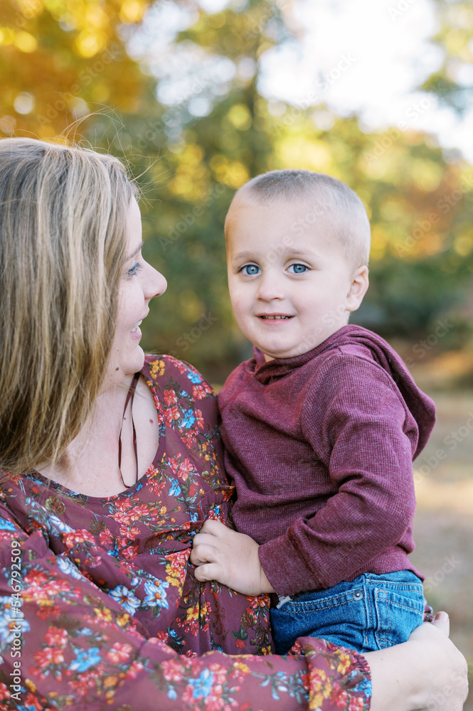 Smiling mother hugging her son outdoors Smiling mother hugging her son outdoors