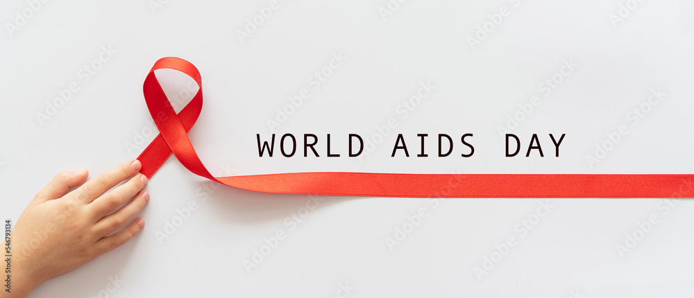 World Aids Day. Child palms red ribbon over white background. symbol of ...