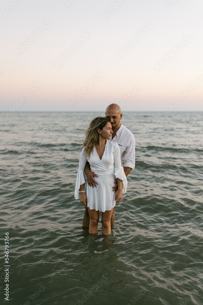 Young couple hugging and kissing in the water Young couple hugging and kissing in the water
