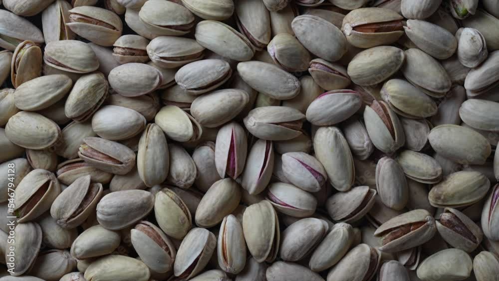 Pistachios texture and background. Pile pistachio kernels nuts with shell, rotate, close up. Pistachio nuts. Whole nut kernels Pistachios texture and background. Pile pistachio kernels nuts with shell, rotate, close up. Pistachio nuts. Whole nut kernels