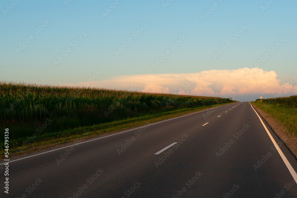 Beautiful orange sunset over the empty road with soft selective focus. Beauty of nature concept