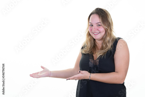 happy plump woman pointing finger and open palm hands demonstrating something object