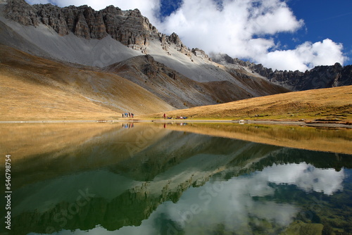 Obraz na płótnie Souliers lake located above Izoard Pass (after one hour hike from Casse deserte car park), with reflections of mountain range and Autumn colors, Queyras Regional Natural Park, Southern Alps, France w salonie