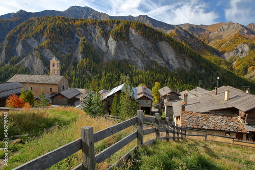 The church of Saint Veran and traditional houses, with mountains in the background and Autumn colors, Queyras Regional Natural Park, Southern Alps, France photo