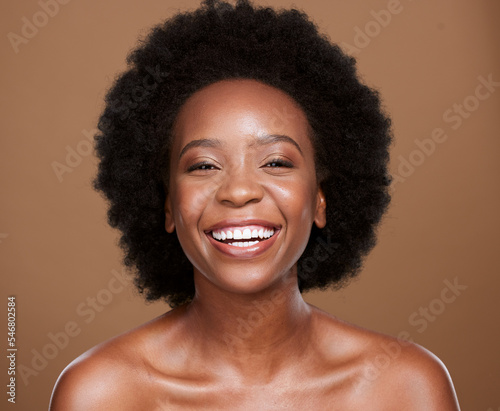 Beauty, skincare and portrait of black woman in studio for wellness, health and organic face treatment. Happy, smile and young model with natural facial and skin routine isolated by brown background.