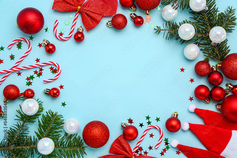 Frame made of beautiful Christmas decorations and fir branches on color background Frame made of beautiful Christmas decorations and fir branches on color background