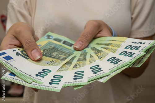 wad of money in hand, 100 euro banknotes