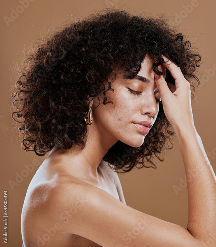 Skincare, self care and woman with beauty from hair care, makeup and cosmetics against a brown studio background. Marketing, wellness and model advertising natural dermatology and cosmetic glow