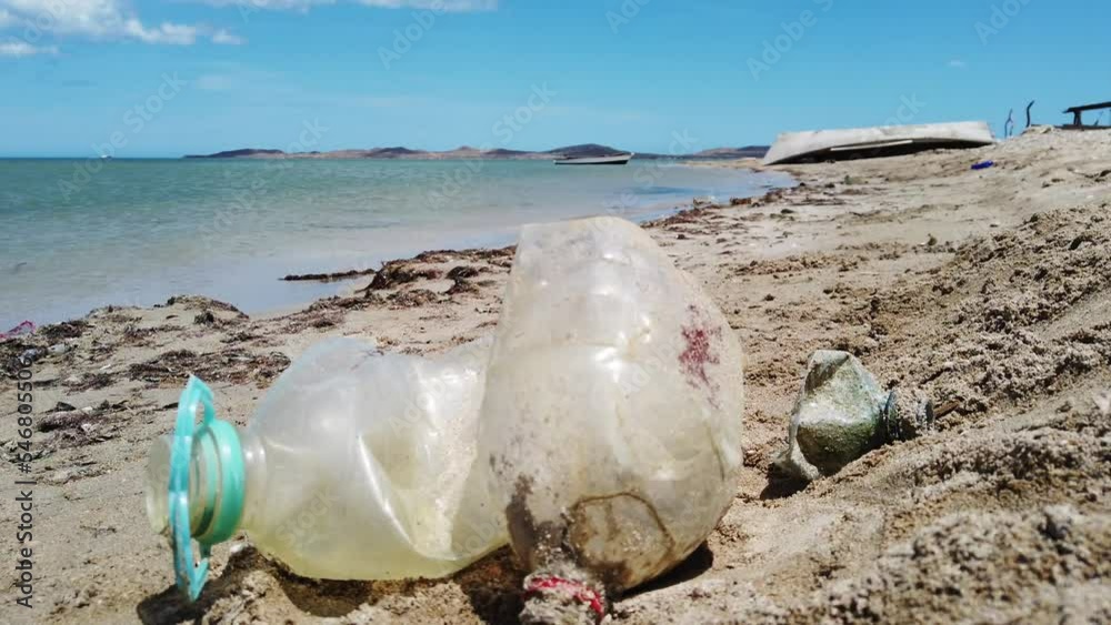 plastic waste pollutes the sea and beaches on the Caribbean ocean coast in Cabo de la Vela, Guajira Colombia - bottle of plastic near the sea - contamination of the seas, Save the planet plastic waste pollutes the sea and beaches on the Caribbean ocean coast in Cabo de la Vela, Guajira Colombia - bottle of plastic near the sea - contamination of the seas, Save the planet