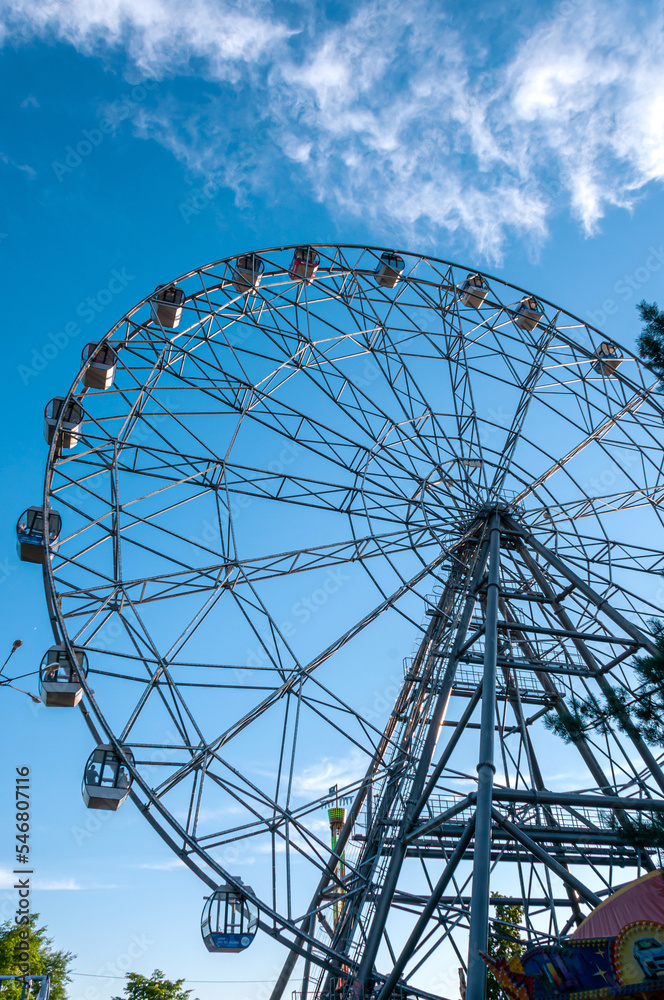 Khabarovsk, Russia, July 10, 2022: Ferris wheel on the Amur embankment in Khabarovsk against the blue sky