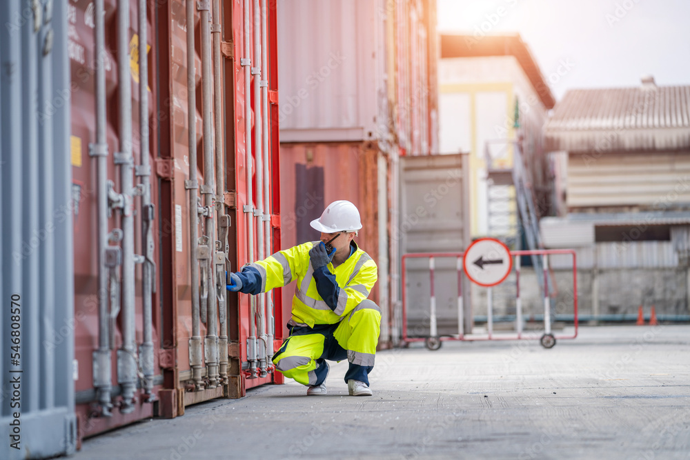 Container operator inspection containers box from cargo ship for export and import at container yards. Container operator inspection containers box from cargo ship for export and import at container yards.