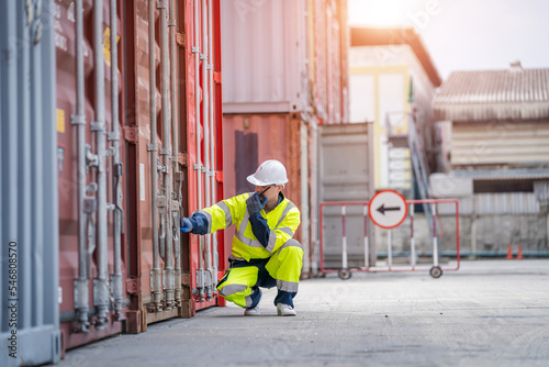 Container operator inspection containers box from cargo ship for export and import at container yards.