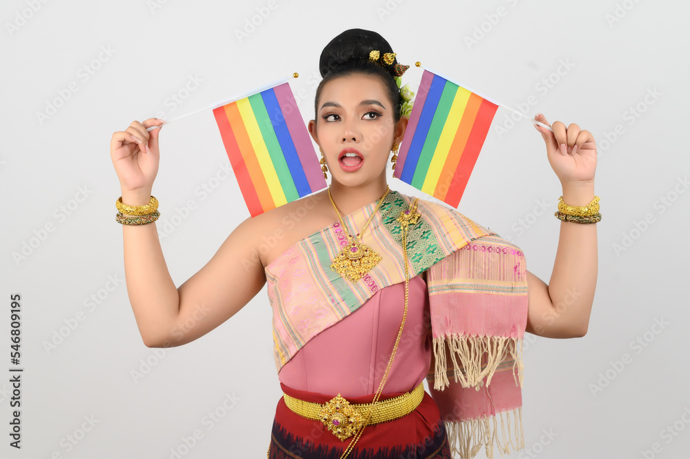 Portrait of Young woman in Thai Northeastern Traditional Clothing holding rainbow flag Portrait of Young woman in Thai Northeastern Traditional Clothing holding rainbow flag