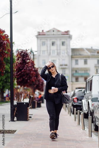 Wallpaper Mural Outdoors lifestyle portrait of stunning brunette girl. Drinking coffee and walking on the city street. Torontodigital.ca