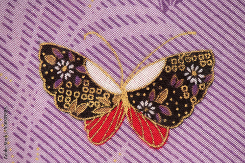 Butterfly pattern part of the old japanese fabric pattern on purple background. photo