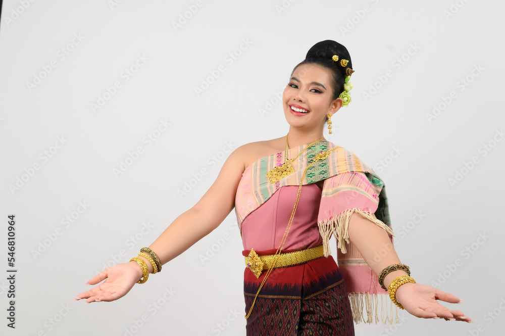 Young beautiful woman in northeastern dress stand and open palm posture