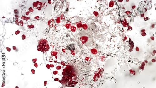 Slow Motion of Explosion Pomegranate Seeds and Burst Water photo
