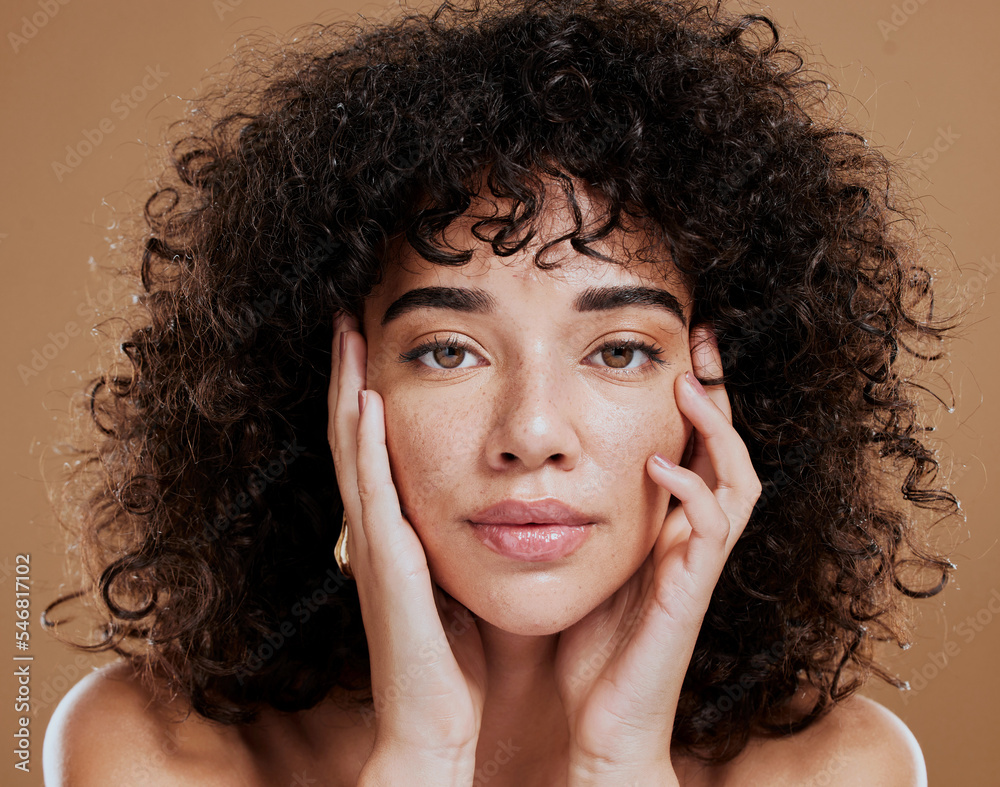 © Jade M/peopleimages.com - Woman, hands on face and afro hair care for beauty wellness in studio. Skincare dermatology wellness, African girl model portrait and cosmetics makeup headshot for healthy natural skin or facial care