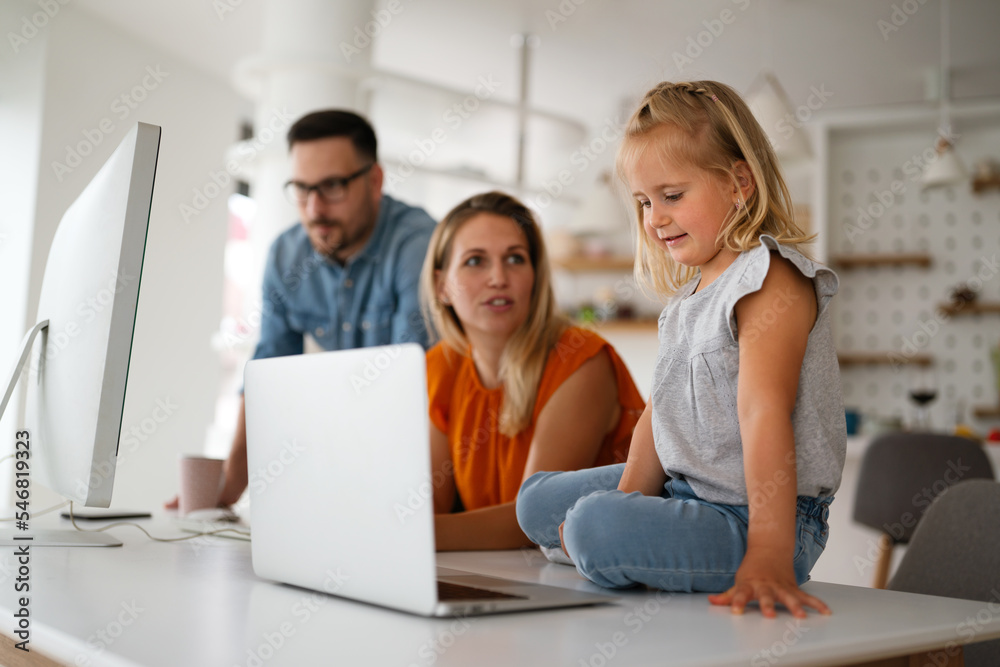 Working from home with child. Busy business parents working while kid playing on laptop. Working from home with child. Busy business parents working while kid playing on laptop.
