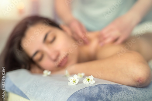 Pretty slim woman receiving a health massage treatment in a spa center
