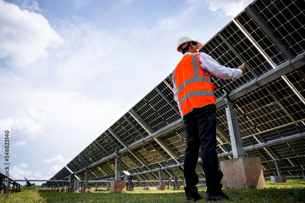 Businessman on a tour of solar power plants to check the operation of the power generation system. solar panels are an alternative electricity source to be sustainable resources in the future Businessman on a tour of solar power plants to check the operation of the power generation system. solar panels are an alternative electricity source to be sustainable resources in the future