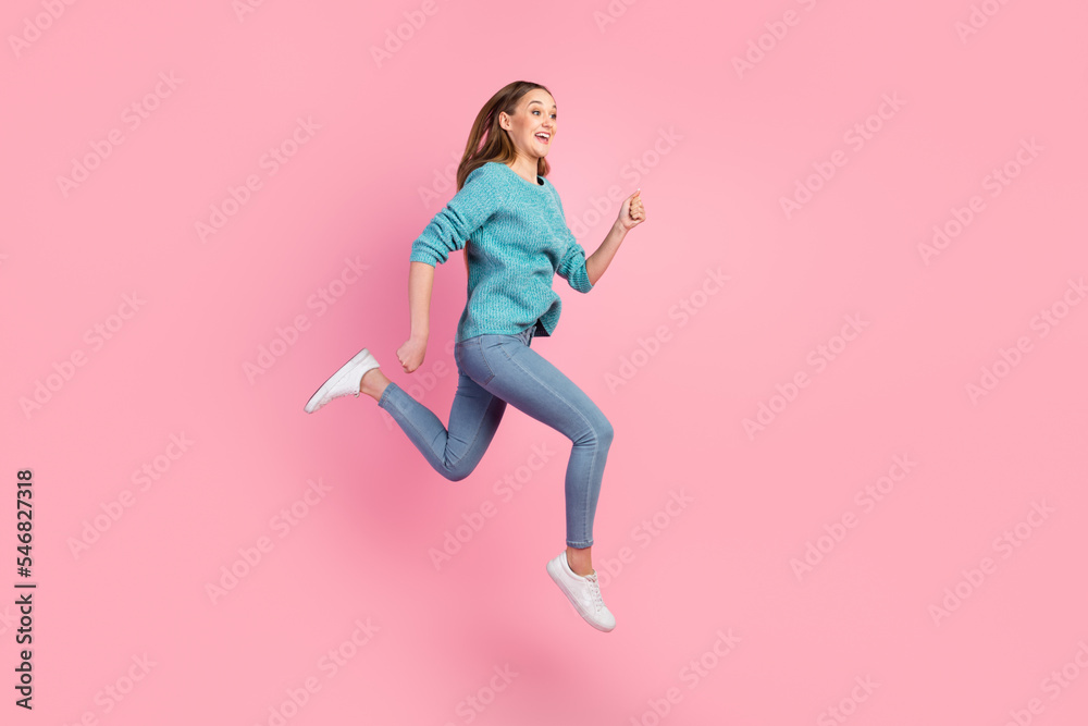 Full length body view of lovely cheerful girl jumping running isolated on pastel color background