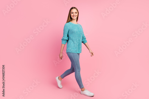 Casual young woman walking with smile isolated on pastel color background