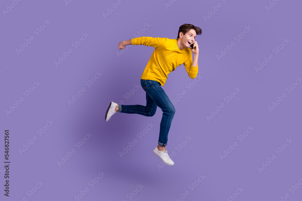 Full body photo of handsome guy jumping high talking telephone rushing wear casual shirt isolated bright color background