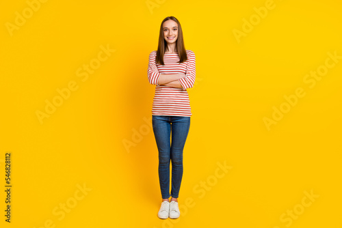 Full body photo of optimistic modern lady freelancer stand with crossed arms studio shot shine background