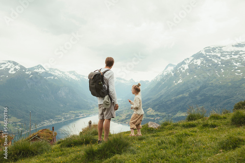 Father and daughter hiking on mountain photo