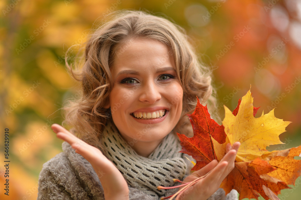 Beautiful woman walking in the park in autumn Beautiful woman walking in the park in autumn