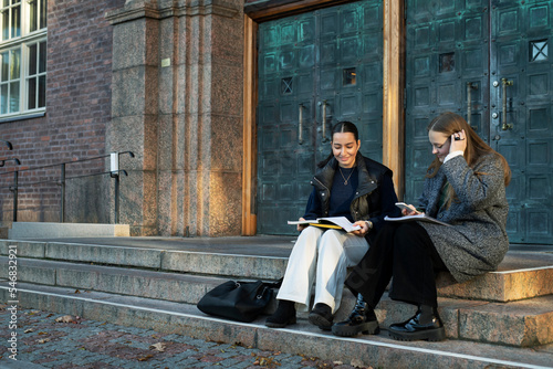Young women studying on steps