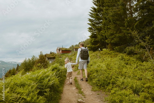 Father and daughter hiking on trail photo