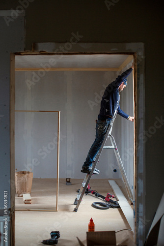 Man on ladder during home renovation photo