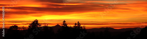 orange sunset over Jizera Mountains with Ještěd mountain, background with sunset