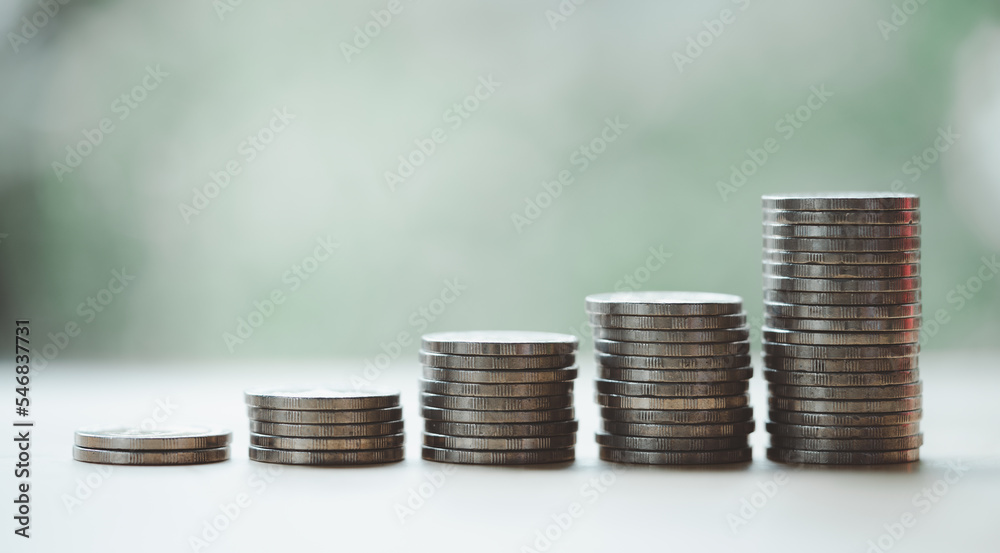 Cash flow growth from long-term sustainable investments, financial concept. Five increasing-height coin stacks with a green bokeh background, depicting saving money for retirement. Cash flow growth from long-term sustainable investments, financial concept. Five increasing-height coin stacks with a green bokeh background, depicting saving money for retirement.