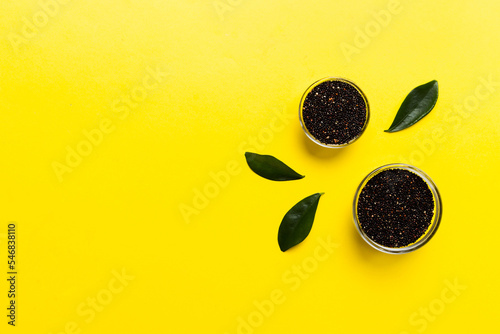 quinoa seeds in bowl on colored background. Healthy kinwa in small bowl. Healthy superfood photo