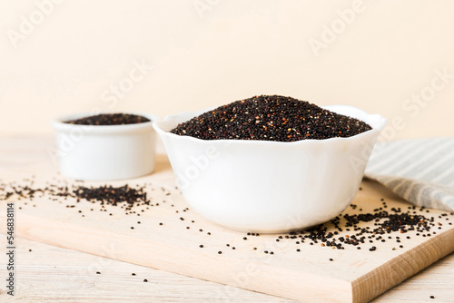 quinoa seeds in bowl on colored background. Healthy kinwa in small bowl. Healthy superfood