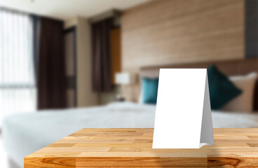 White sign cardboard with copy space on a white round table. Hotel interior