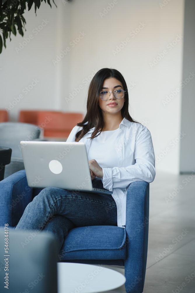 Beautiful Caucasian woman dreaming about something while sitting with portable net-book in modern cafe bar, young charming female freelancer thinking about new ideas during work on laptop computer Beautiful Caucasian woman dreaming about something while sitting with portable net-book in modern cafe bar, young charming female freelancer thinking about new ideas during work on laptop computer