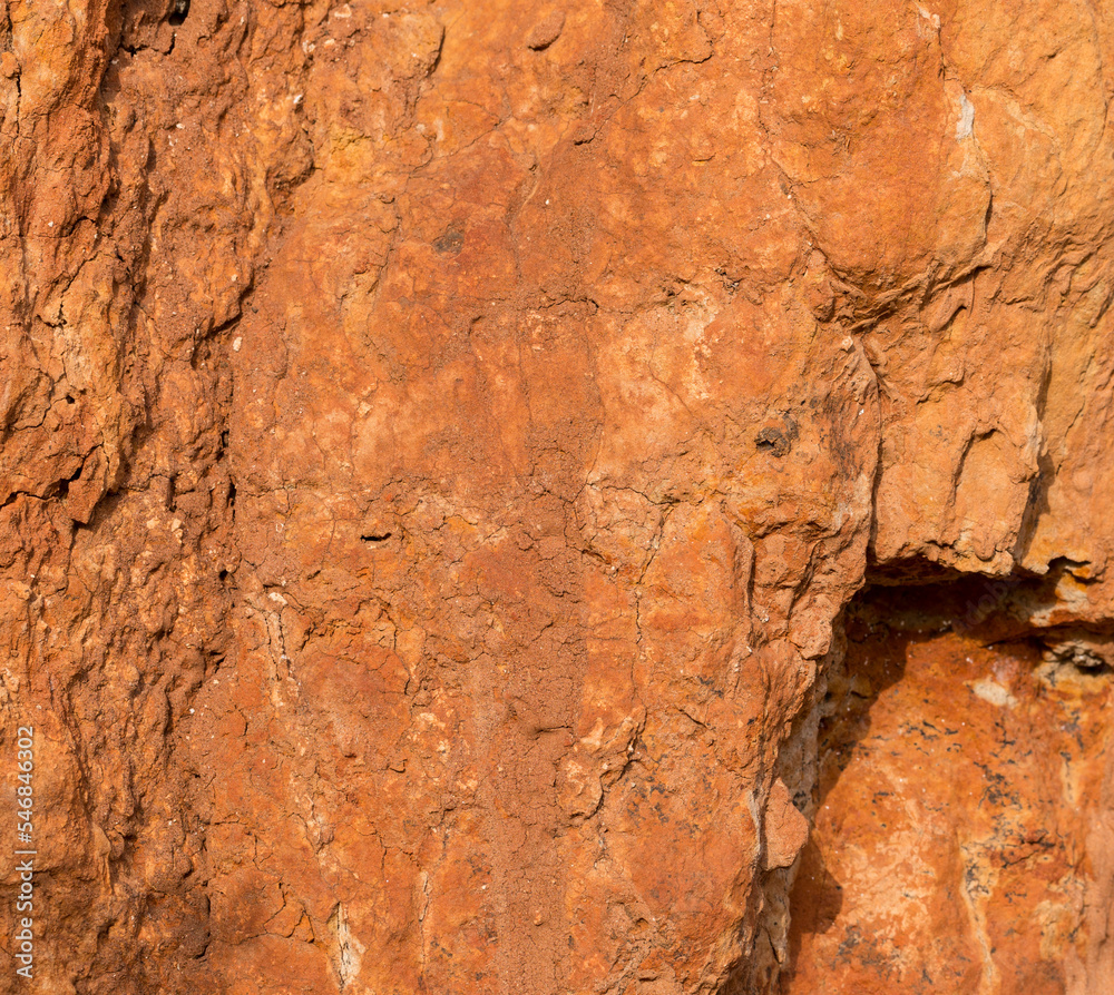 Sedimentary rocks with a high content of iron oxide. Red soil, loam. The texture of the soil. Sedimentary rocks with a high content of iron oxide. Red soil, loam. The texture of the soil.