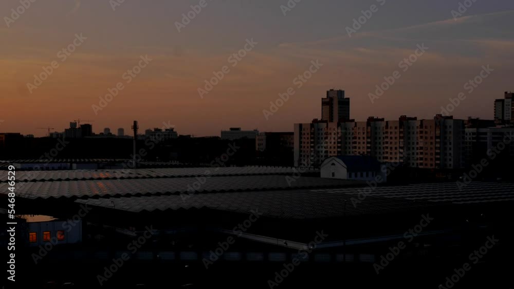 Sunset Hyperlapse. The sun slowly descends behind the buildings of the city and goes beyond the horizon. Clouds float beautifully and smoothly across the sky. Minsk, Belarus. Sunset Hyperlapse. The sun slowly descends behind the buildings of the city and goes beyond the horizon. Clouds float beautifully and smoothly across the sky. Minsk, Belarus.