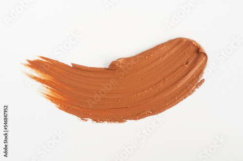 Red moroccan bentonite clay swatch. Brush stroke on a white background. Beauty cream, facial mask texture macro.