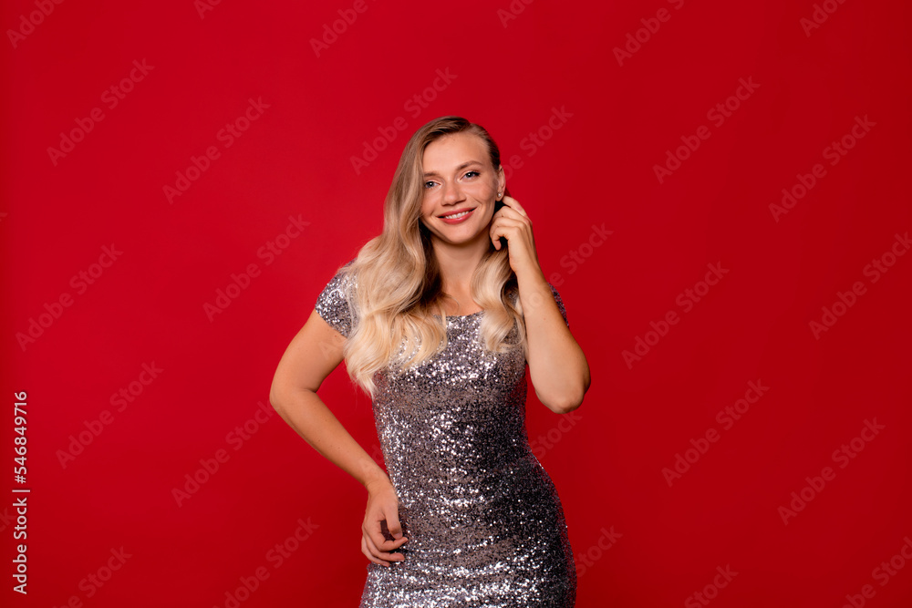 style, beauty, makeup and cosmetics concept. woman in silver evening sequined dress on red background style, beauty, makeup and cosmetics concept. woman in silver evening sequined dress on red background