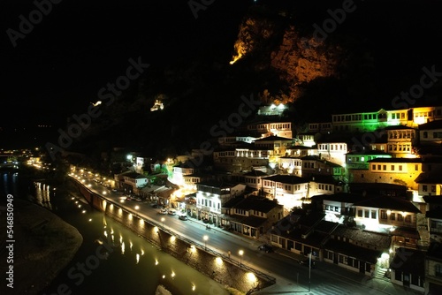 Berat is a city on the Osum River, known for its white Ottoman houses and castle on the hill, aerial night view of this historical city,Albania,Europe