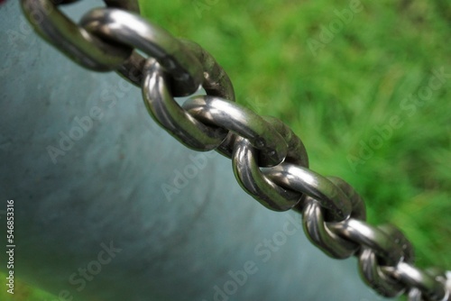 Chain of sturdy material. Metal, iron stainless steel that connects and fastens what is loose. Chained and depriving freedom and safety guaranteed.