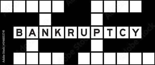 Alphabet letter in word bankruptcy on crossword puzzle background