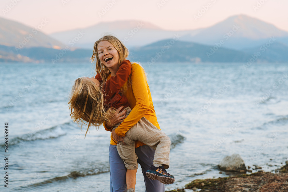 Mother and daughter having fun outdoor family travel together summer vacations lifestyle woman playing with child at the lake Mothers day holiday